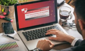 Man looking at his laptop attacked by ransomware
